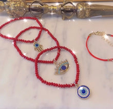 Trio Red Beaded Evil Eye charm stack bracelets.