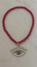 Trio Red Beaded Evil Eye charm stack bracelets.