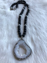 Open Crystal Druzy pendant surrounded by matte Agate & Black Lava stones.