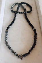 Beaded Stretch Necklace in Hematite, Black Lava, and Matte Obsidian Skull Pendant.