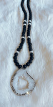 Open Crystal Druzy pendant surrounded by matte Agate & Black Lava stones.